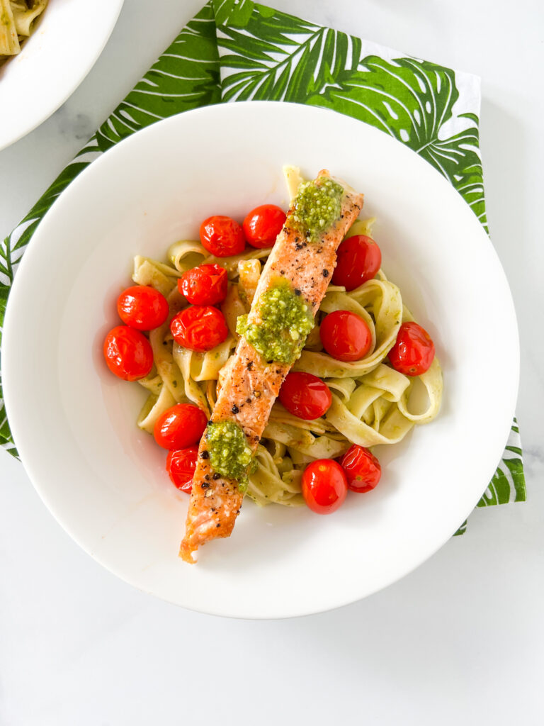 salmon pesto pasta served in a bowl with  blistered grape tomatoes 2