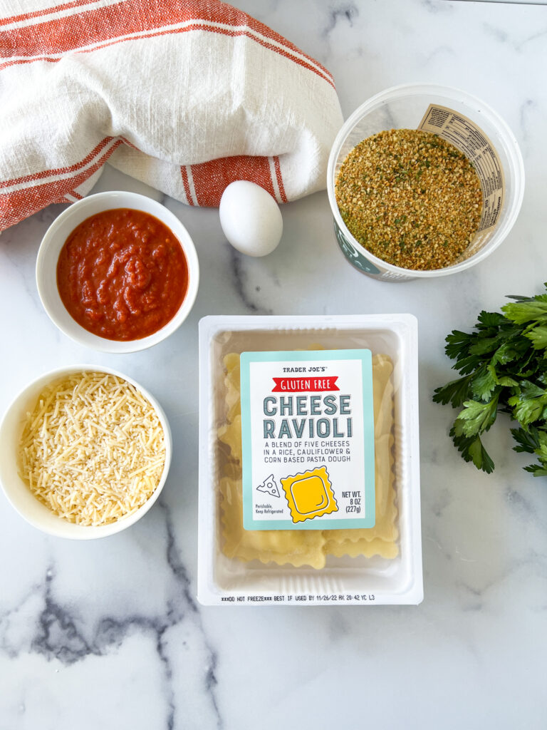ingredients for toasted ravioli including trader joe's gluten-free ravioli, breadcrumbs, egg, marinara, and parmesan cheese