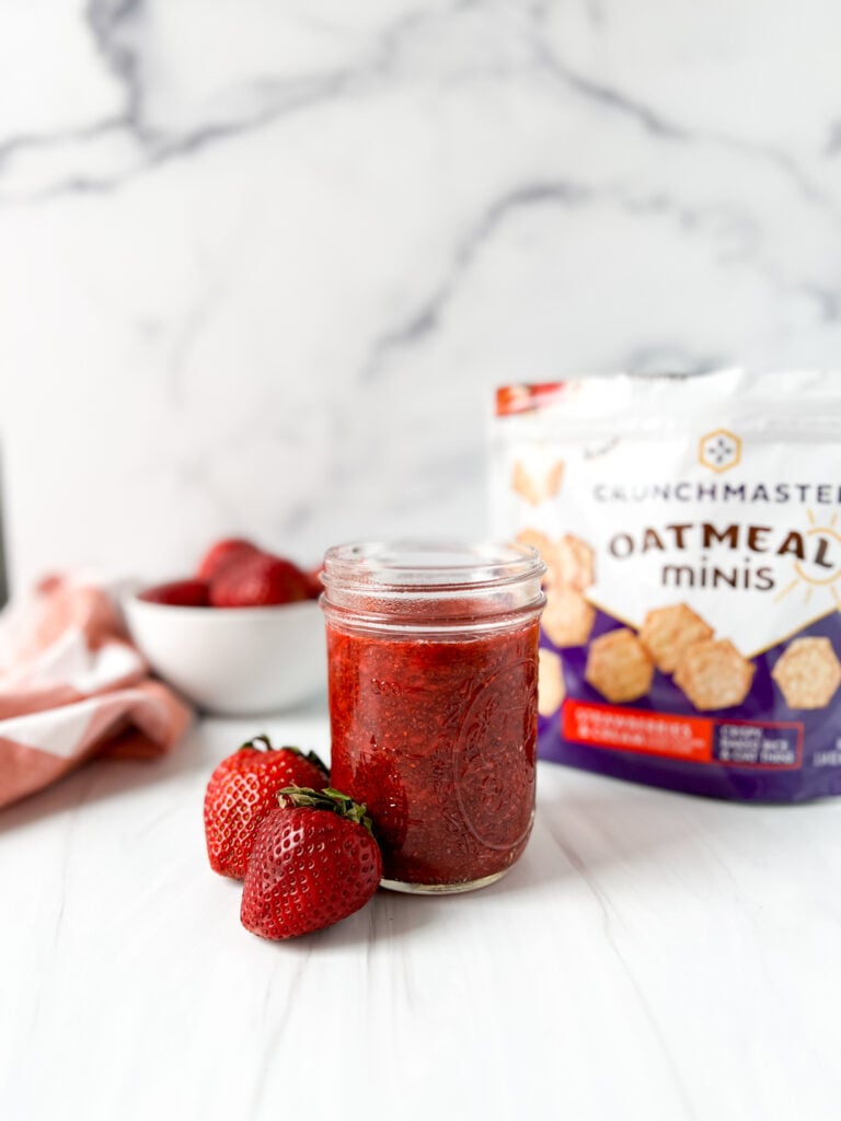 strawberry chia jam in a mason jar with crackers
