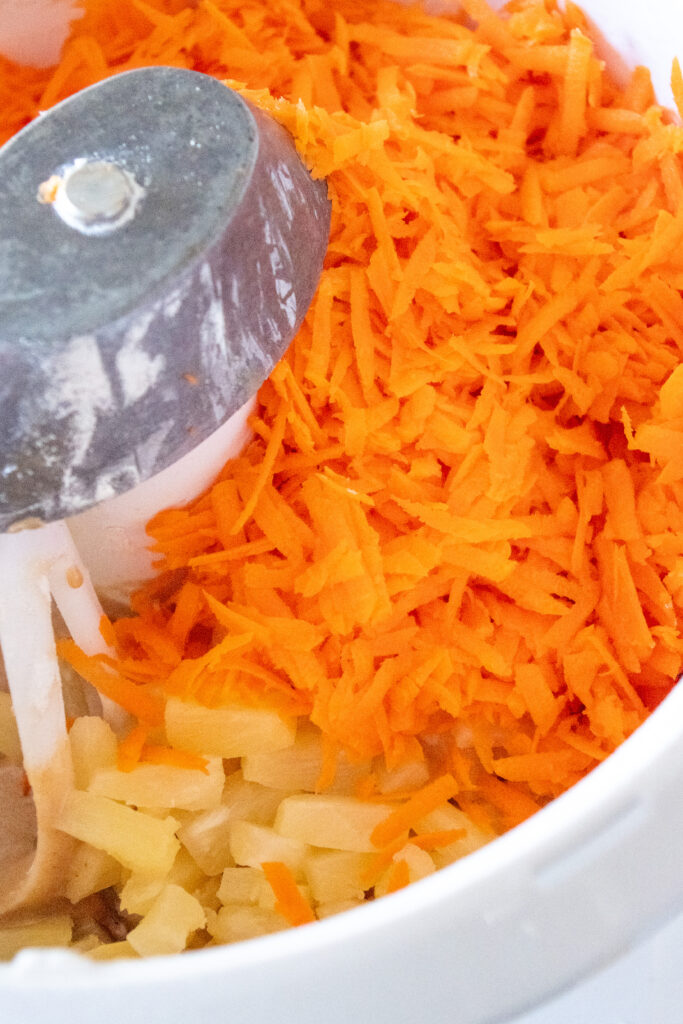 adding the shredded carrots to the mixer