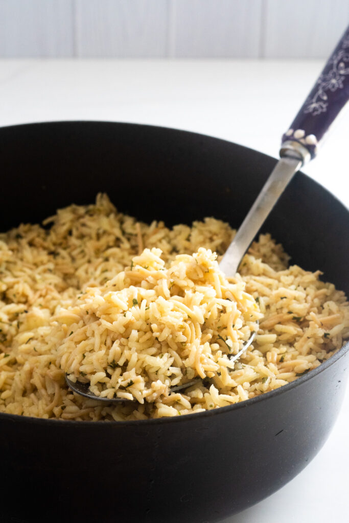 gluten-free rice-a-roni in a pan with a spoon