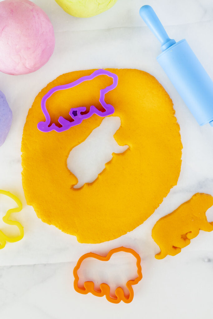cutting play dough into shapes