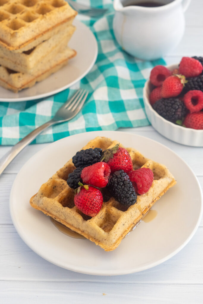 protein waffle with berries and maple syrup on top
