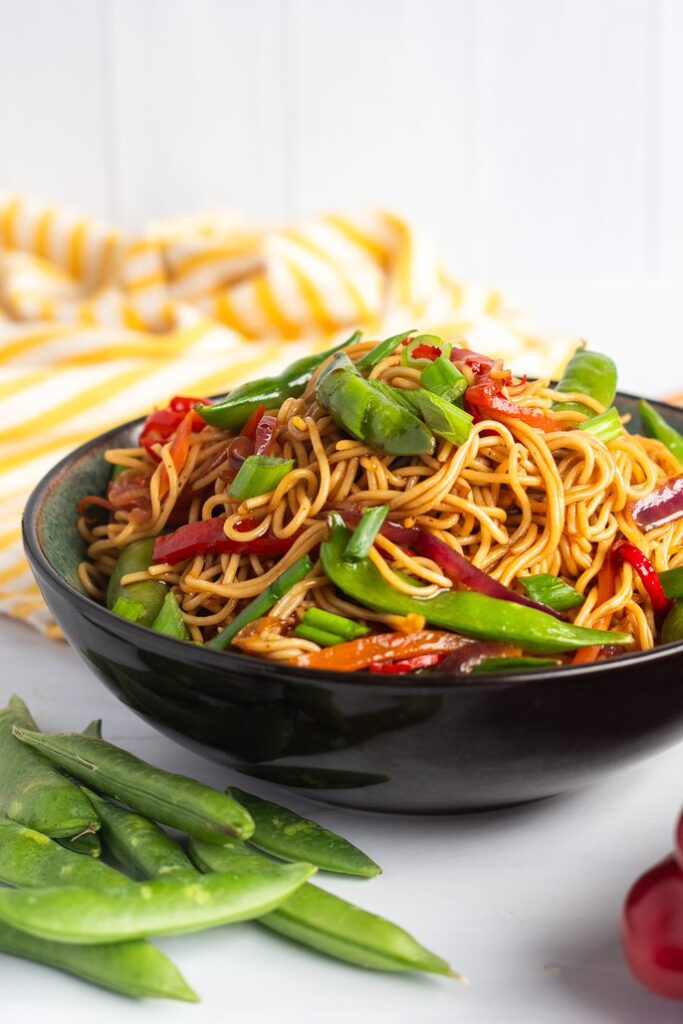 bowl of vegetable lo mein with garnish